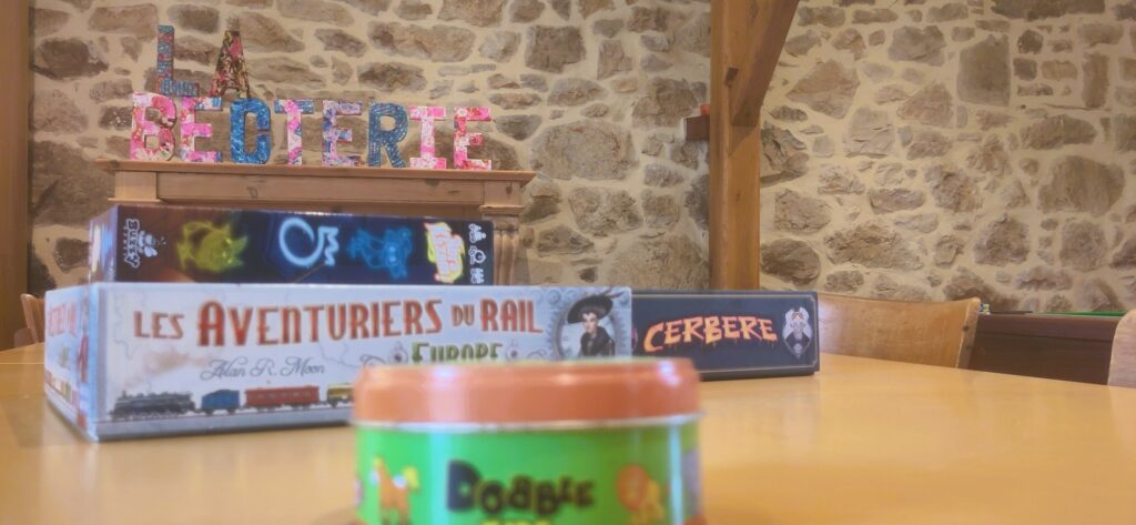 Some of the many board games arranged on the table dedicated to game events.