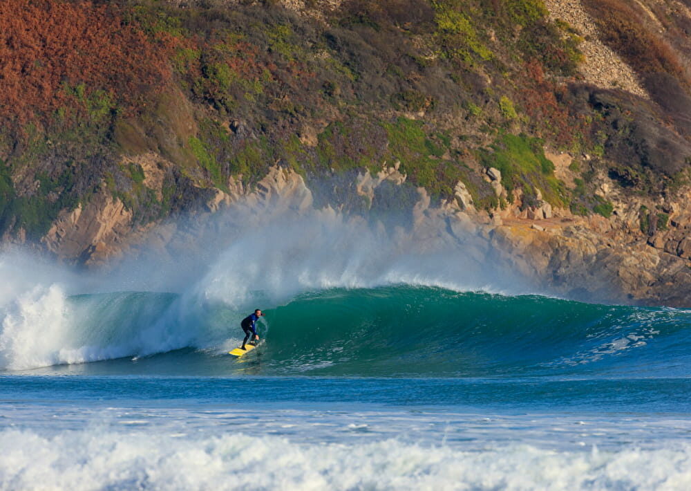 A surfer enjoying a big wave in Sciotot